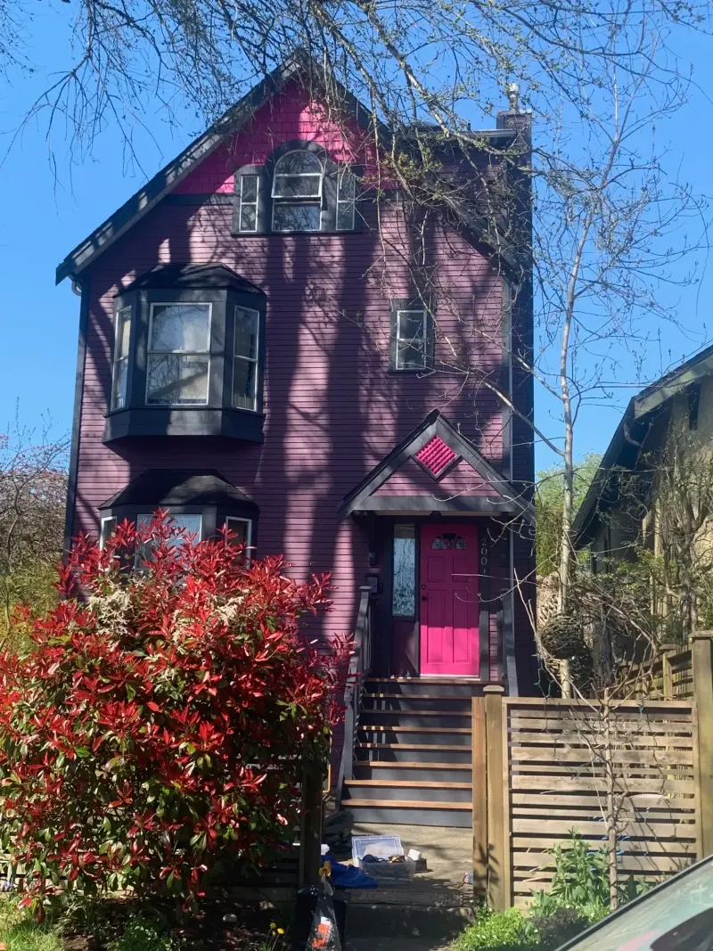 Completed exterior house painting at East Vancouver BC, bold purple siding, charcoal grey trim, pink front door by Colour Craft Painting